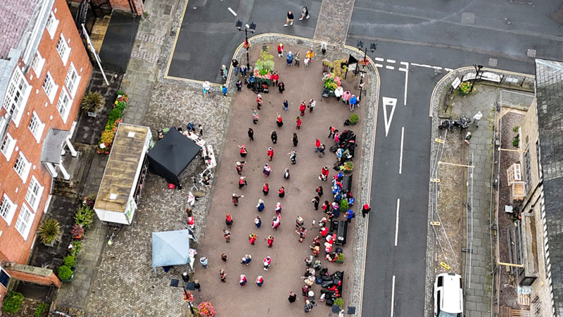 drone picture of the massed dance showing all participating morris sides lined up ready to start