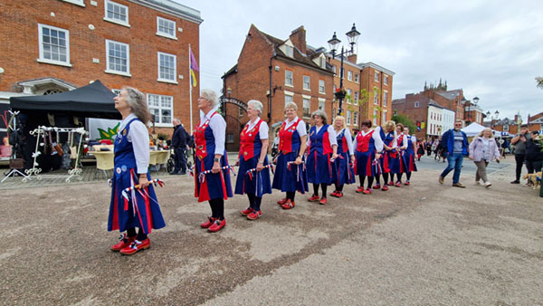 Dancers lined up across a spacious Castle Square ready to start dancing Alvechurch