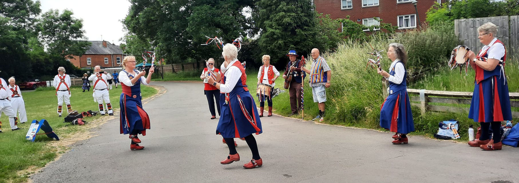 nancy butterfly dancing and being watched by White Hart Morris men