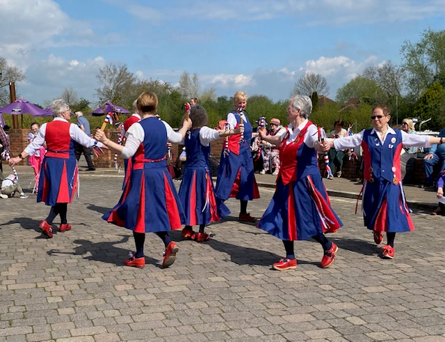 dancing on a sunny day in Upton with large crowd watching